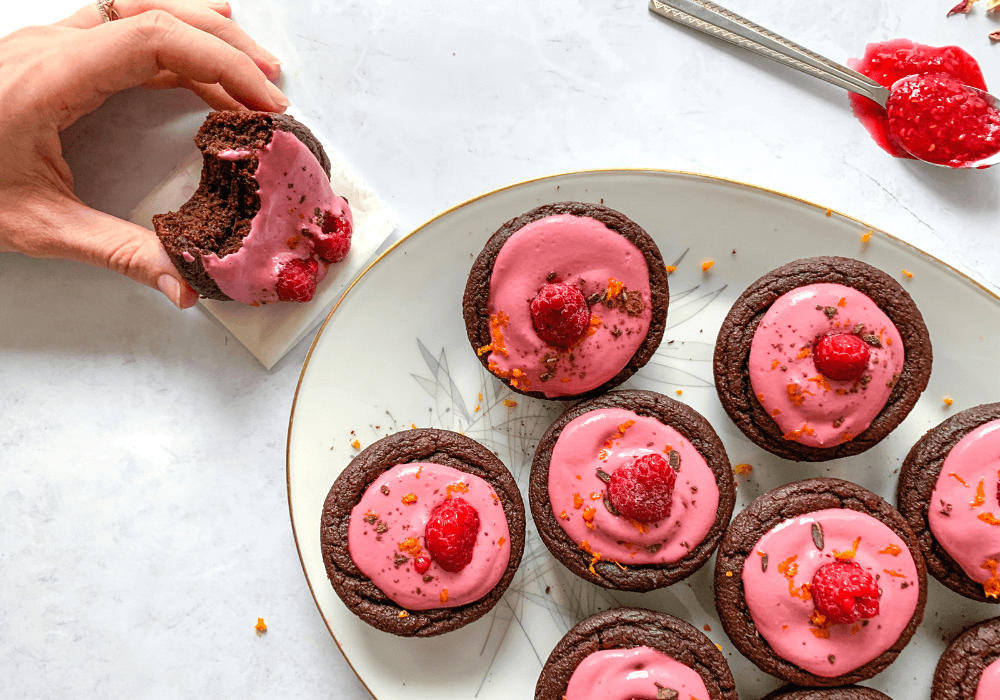Image showing chocolate beet cupcakes decorated with raspberry frosting and the texture of one of the cupcakes with a bite taken out of it