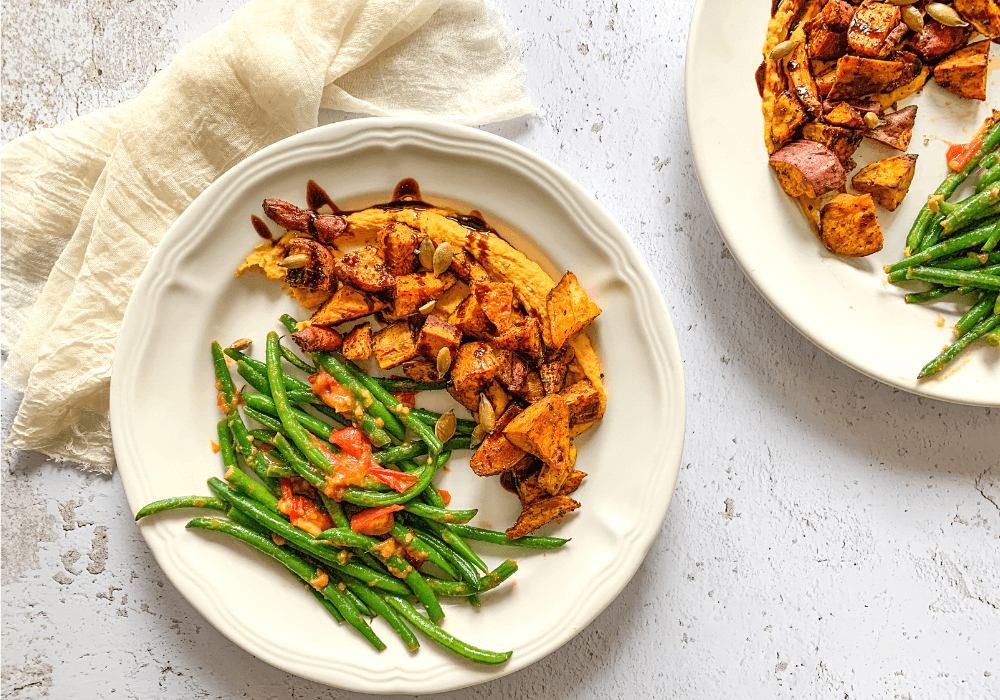 This image shows the lunch formula as a meal of hummus, roasted veggies, and greens on a plate.