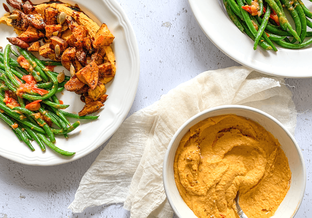 This image shows the easy lunch formula I use to make lunches for the whole week with bean dip, roasted veggies, and a green vegetable.