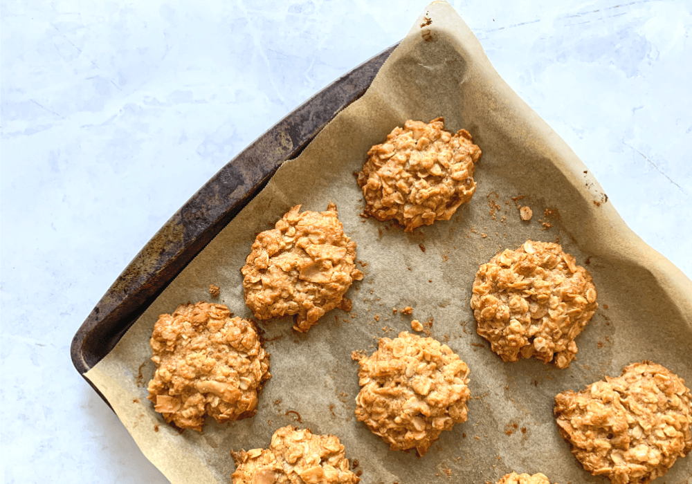 This image shows the peanut oat cookies on a baking sheet after they're cooked.