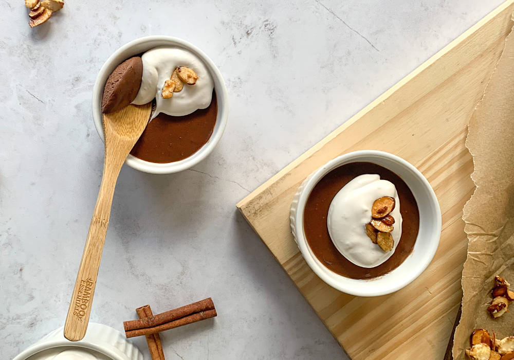This image shows the Mexican Chocolate Pots de Creme with coconut whipped cream and candied almonds on top. 