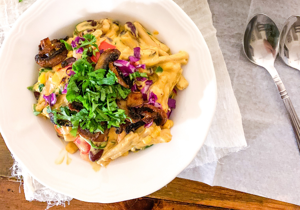 Healthy loaded mac & cheese with crispy smoky mushrooms in a bowl. 