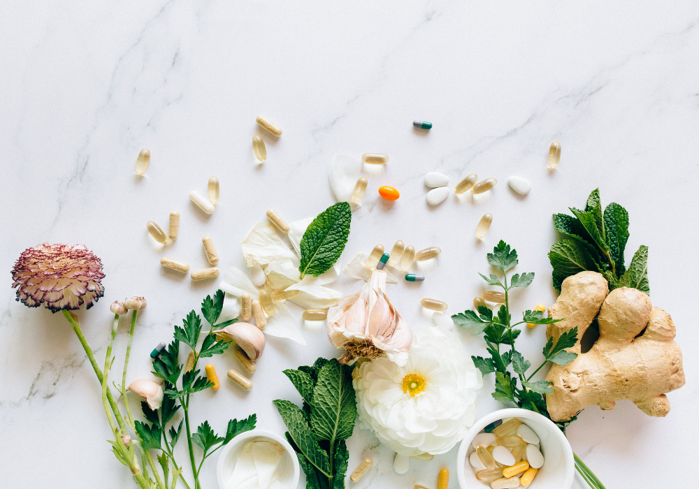 This image shows synthetic and whole food supplements on a marble background.