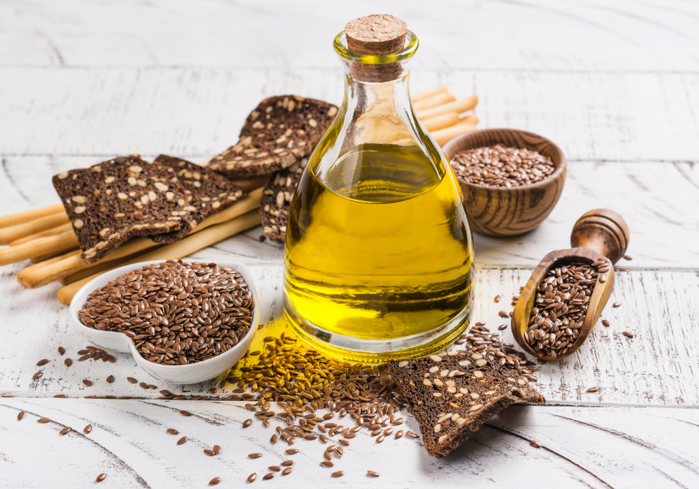 This image shows flaxseeds, flax oil, and flax crackers on a table.