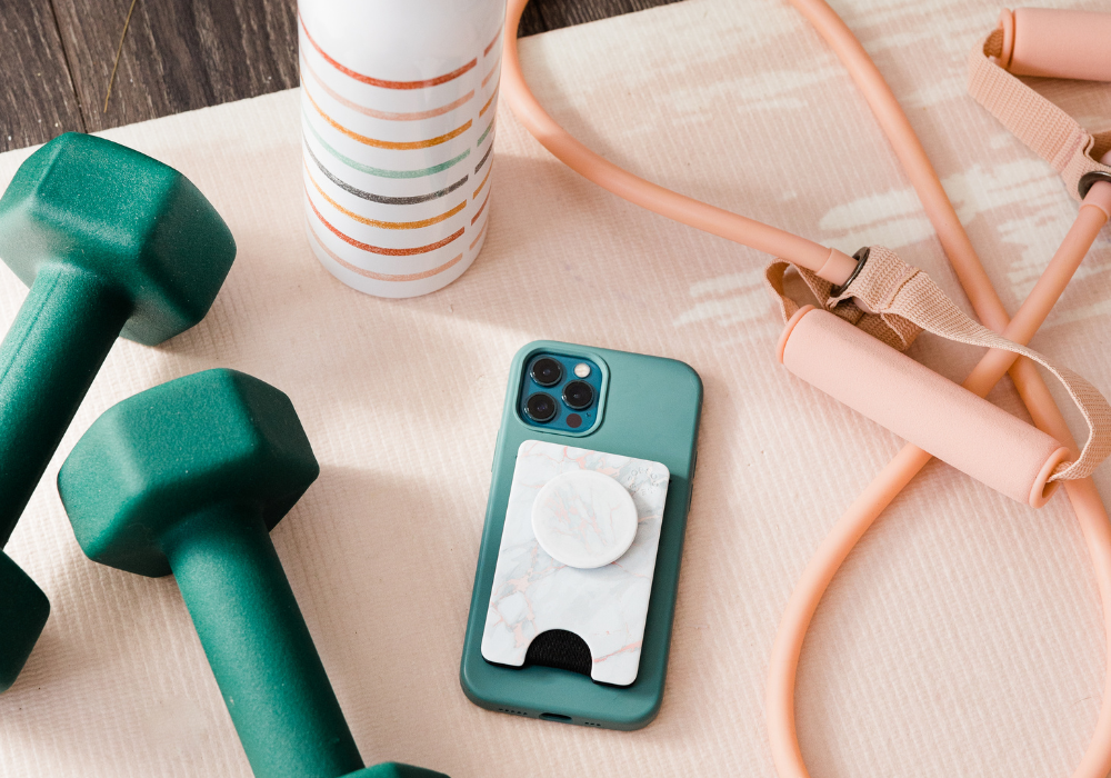Image of weights, a water bottle, an iPhone, and a pink jump rope.