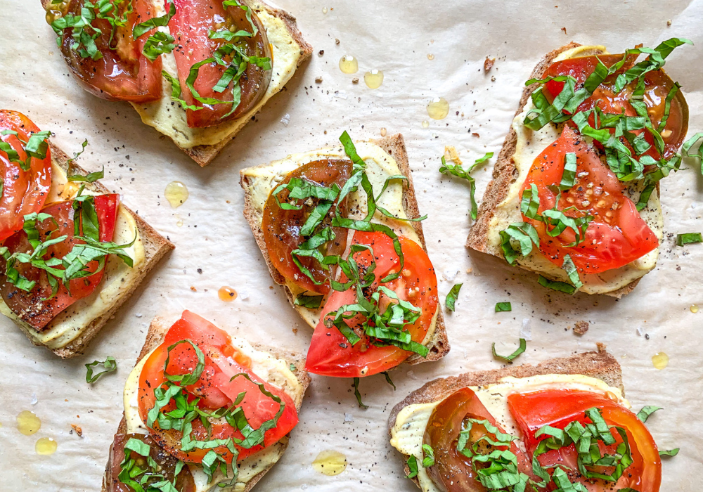 This is an image of a standard breakfast I eat during pregnancy of several pieces of toast with tofu ricotta and sliced tomatoes on top.